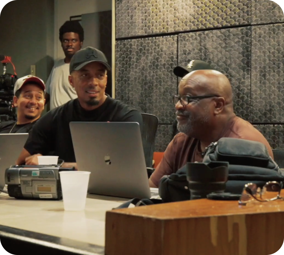 Creative professionals collaborating in a studio with laptops and film equipment